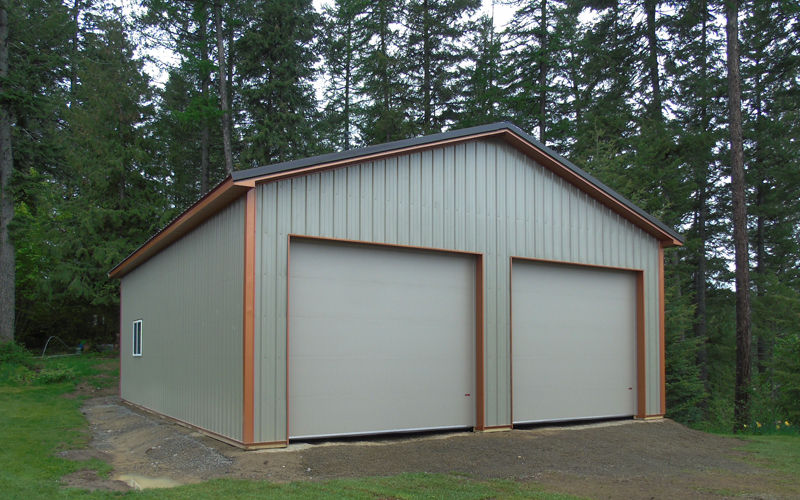 Pole Barn Garage with 2 doors. Copper trim Dark Roof